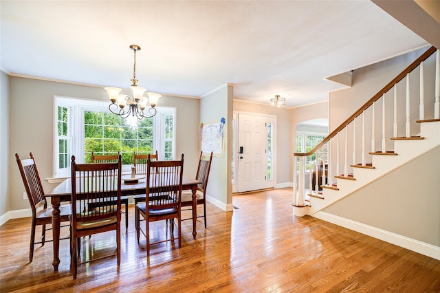 14 Flower Hill Rd, Poughkeepsie, NY 12603 - dining area featuring a chandelier, stairs, wood finished floors, ornamental molding, and arched walkways