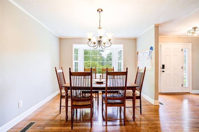 14 Flower Hill Rd, Poughkeepsie, NY 12603 - dining space featuring a chandelier, light wood finished floors, and ornamental molding