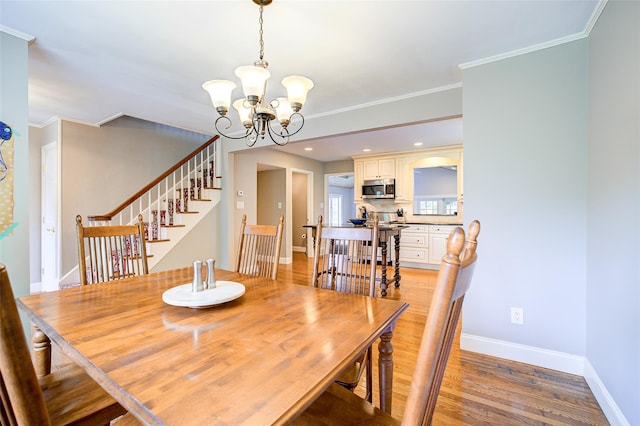 14 Flower Hill Rd, Poughkeepsie, NY 12603 - dining space with a chandelier, light wood-style flooring, stairway, and ornamental molding