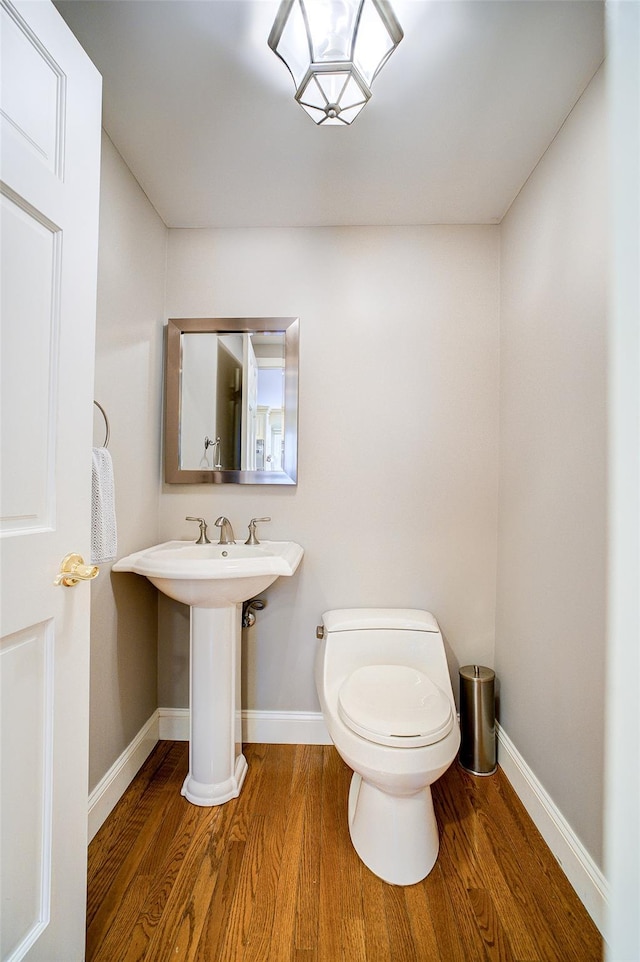14 Flower Hill Rd, Poughkeepsie, NY 12603 - half bathroom with wood finished floors and toilet