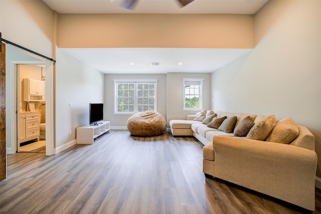14 Flower Hill Rd, Poughkeepsie, NY 12603 - living room featuring wood finished floors, a barn door, and recessed lighting