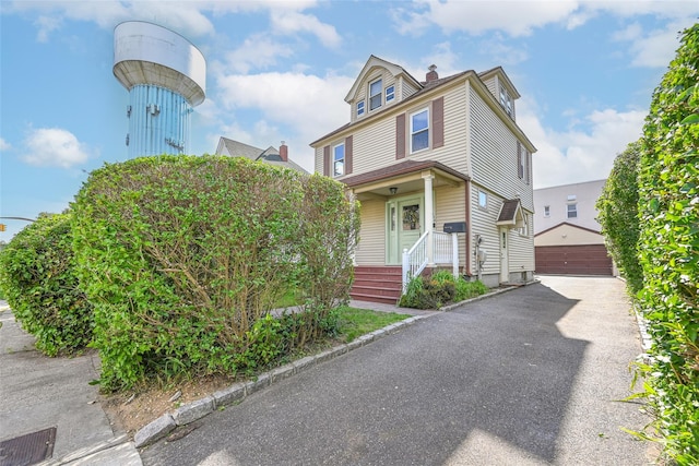 108 N Forest Ave, Rockville Centre, NY 11570 - american foursquare style home featuring an outdoor structure, a detached garage, and a chimney