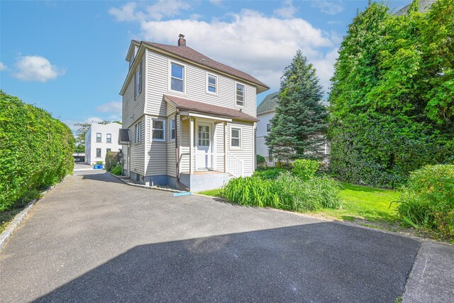 108 N Forest Ave, Rockville Centre, NY 11570 - view of front facade with a chimney