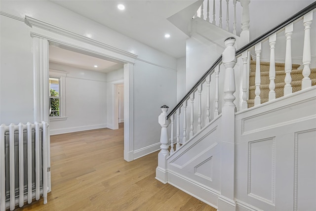 108 N Forest Ave, Rockville Centre, NY 11570 - staircase featuring radiator, wood finished floors, and recessed lighting