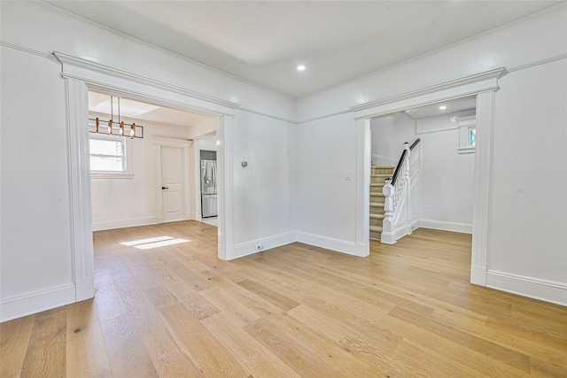 108 N Forest Ave, Rockville Centre, NY 11570 - unfurnished room with stairs, light wood-style flooring, a chandelier, and recessed lighting