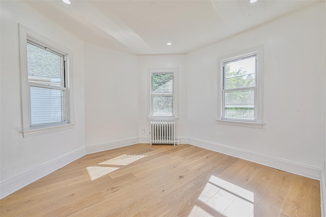 108 N Forest Ave, Rockville Centre, NY 11570 - spare room with radiator, light wood-style floors, and recessed lighting