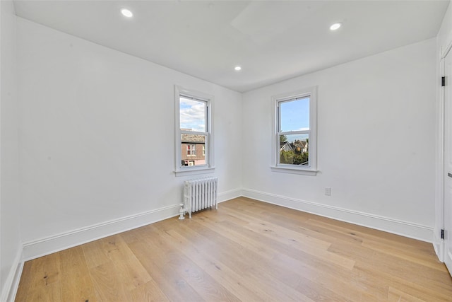 108 N Forest Ave, Rockville Centre, NY 11570 - empty room featuring radiator heating unit, light wood-style flooring, and recessed lighting