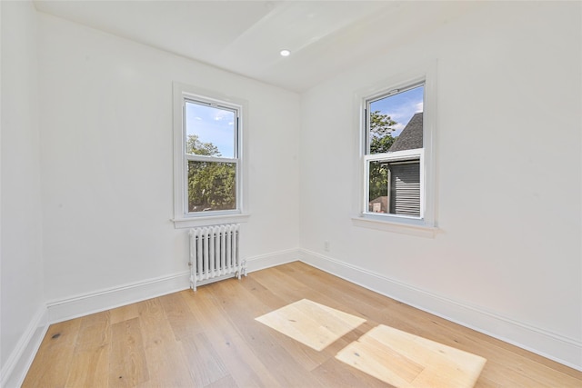 108 N Forest Ave, Rockville Centre, NY 11570 - unfurnished room featuring radiator, plenty of natural light, light wood finished floors, and recessed lighting