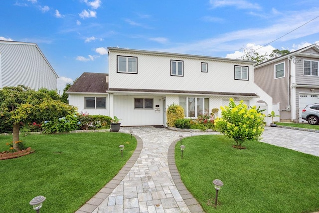 11 Sunrise St, Plainview, NY 11803 - view of front of home with a front lawn and decorative driveway