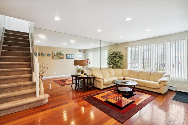 11 Sunrise St, Plainview, NY 11803 - living area featuring a baseboard heating unit, stairs, hardwood / wood-style flooring, and recessed lighting