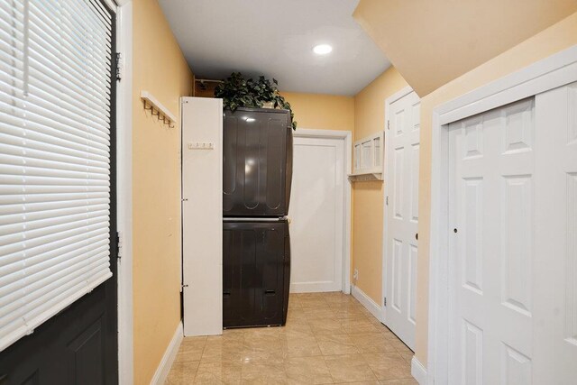 11 Sunrise St, Plainview, NY 11803 - laundry area with stacked washer / dryer and recessed lighting