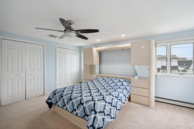 11 Sunrise St, Plainview, NY 11803 - bedroom featuring light carpet, two closets, baseboard heating, recessed lighting, and a ceiling fan