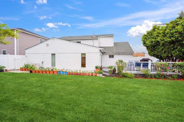 11 Sunrise St, Plainview, NY 11803 - rear view of house with a wooden deck and roof with shingles