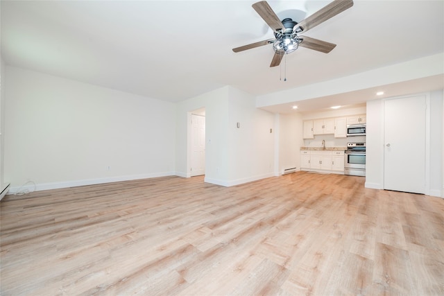 27A Walden Ct Unit A, Yorktown Heights, NY 10598 - unfurnished living room with a baseboard heating unit, light wood-style flooring, ceiling fan, and recessed lighting