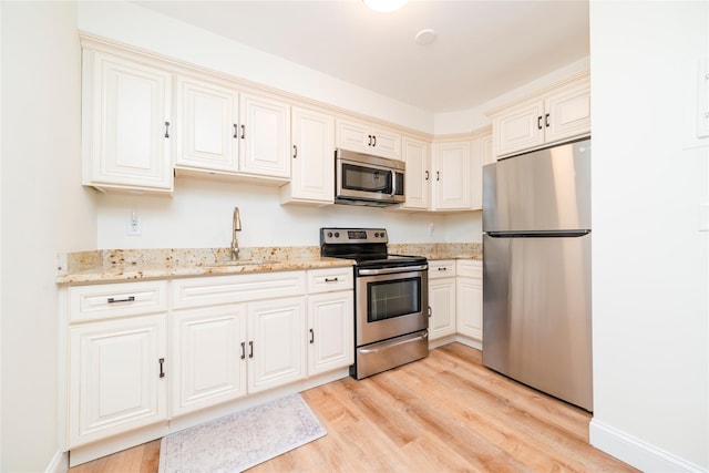 27A Walden Ct Unit A, Yorktown Heights, NY 10598 - kitchen featuring stainless steel appliances, light wood-type flooring, and light stone countertops