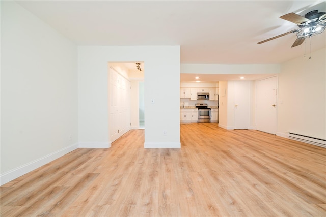 27A Walden Ct Unit A, Yorktown Heights, NY 10598 - unfurnished living room with ceiling fan, a baseboard heating unit, light wood finished floors, and recessed lighting