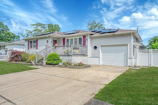 43 Ranch Dr, Shirley, NY 11967 - ranch-style home featuring concrete driveway, a garage, roof mounted solar panels, and covered porch