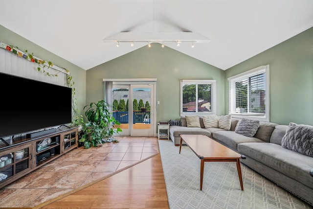 43 Ranch Dr, Shirley, NY 11967 - living room with rail lighting, lofted ceiling, light wood-style flooring, and french doors