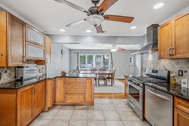 43 Ranch Dr, Shirley, NY 11967 - kitchen featuring wall chimney range hood, appliances with stainless steel finishes, ceiling fan, a peninsula, and crown molding