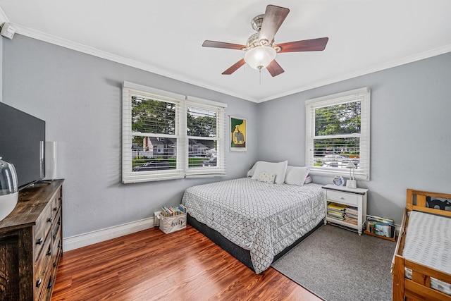 43 Ranch Dr, Shirley, NY 11967 - bedroom featuring multiple windows, crown molding, wood finished floors, and a ceiling fan