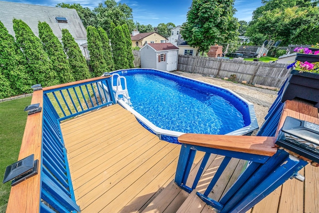43 Ranch Dr, Shirley, NY 11967 - view of swimming pool with a fenced backyard, a storage unit, and a wooden deck