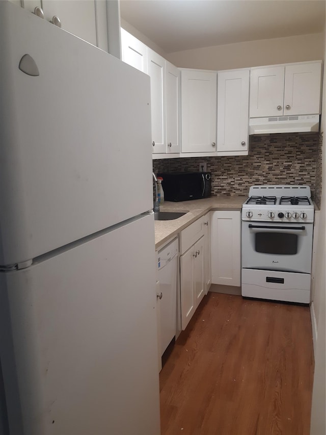 54-40 Little Neck Pkwy Unit 4M, Little Neck, NY 11362 - kitchen with white appliances, under cabinet range hood, white cabinets, and light countertops