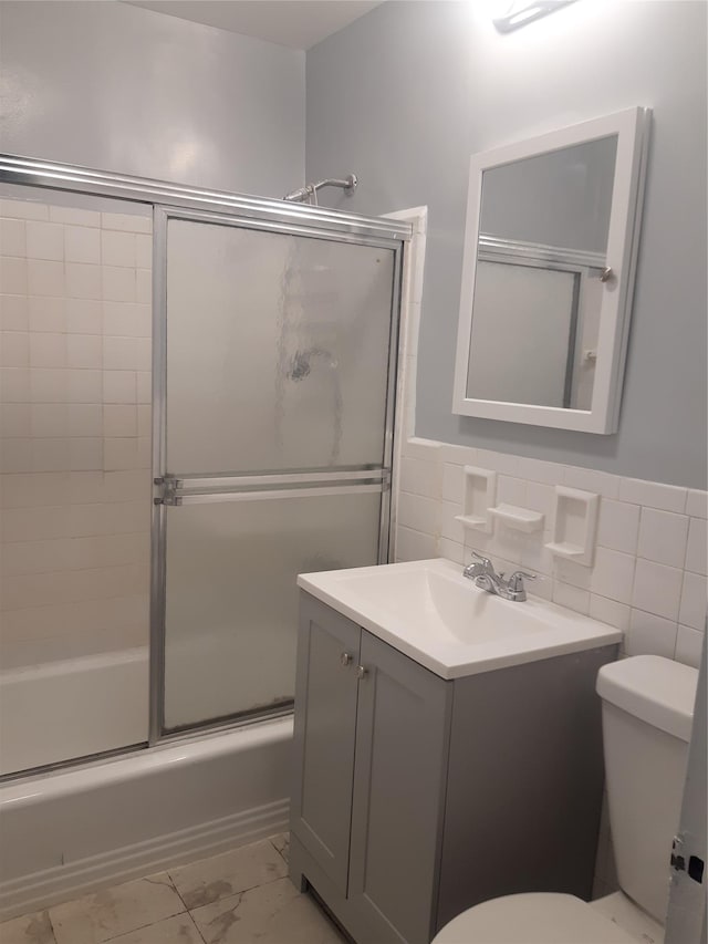 54-40 Little Neck Pkwy Unit 4M, Little Neck, NY 11362 - full bath featuring marble finish flooring, vanity, shower / bath combination with glass door, wainscoting, and tile walls