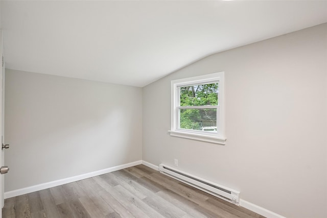 45 Juniper Dr, Lincolndale, NY 10541 - spare room with a baseboard heating unit, lofted ceiling, and wood finished floors