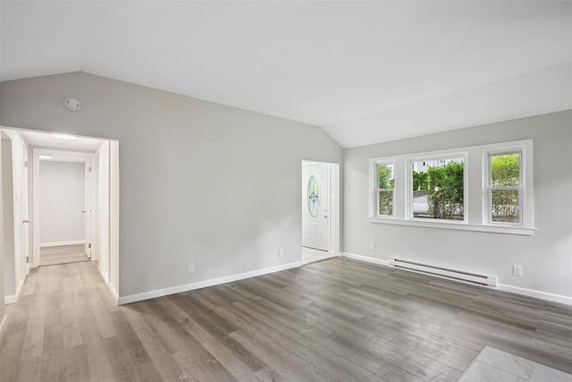 45 Juniper Dr, Lincolndale, NY 10541 - unfurnished living room featuring a baseboard radiator, vaulted ceiling, and wood finished floors