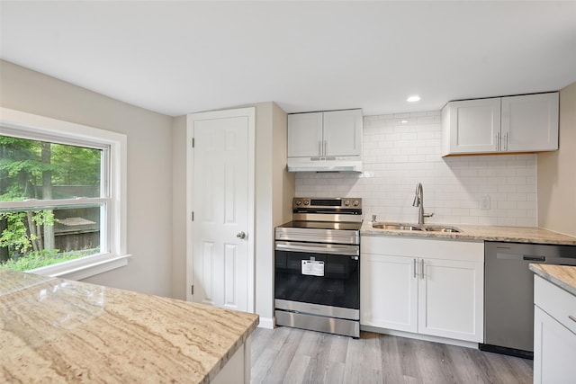 45 Juniper Dr, Lincolndale, NY 10541 - kitchen with stainless steel appliances, under cabinet range hood, decorative backsplash, light wood-style floors, and recessed lighting