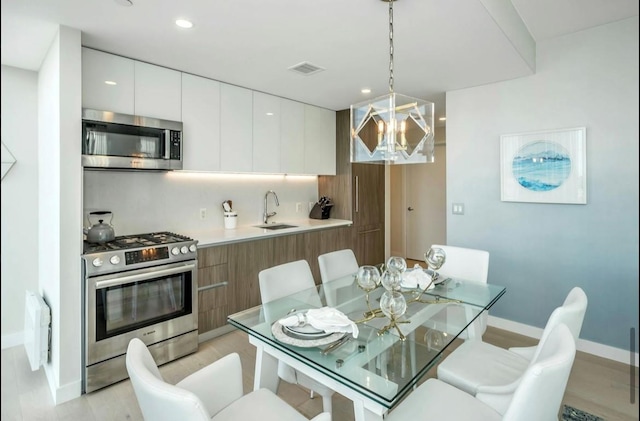 131-01 40th Rd Unit 11N, Flushing, NY 11354 - dining space with a chandelier, light wood finished floors, and recessed lighting