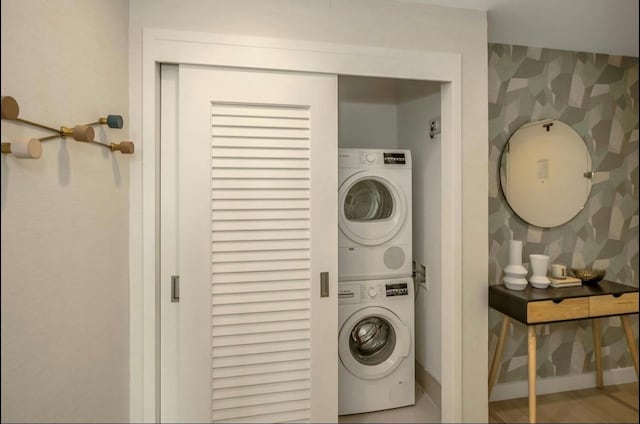 131-01 40th Rd Unit 11N, Flushing, NY 11354 - washroom featuring estacked washer and dryer and baseboards