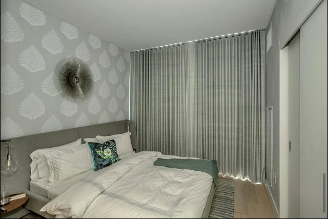 131-01 40th Rd Unit 11N, Flushing, NY 11354 - bedroom featuring wood finished floors and wallpapered walls