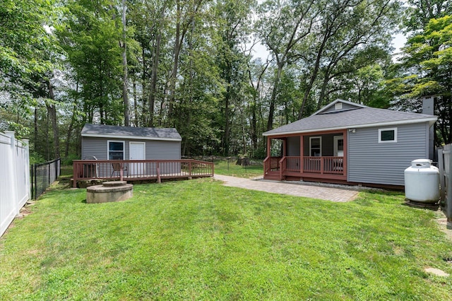 3 Preston Pl, Patterson, NY 12563 - fenced backyard featuring a deck, an outbuilding, and view of wooded area