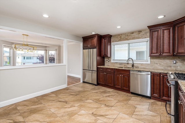 160-46 84th St, Howard Beach, NY 11414 - kitchen featuring appliances with stainless steel finishes, decorative backsplash, plenty of natural light, light stone countertops, and recessed lighting