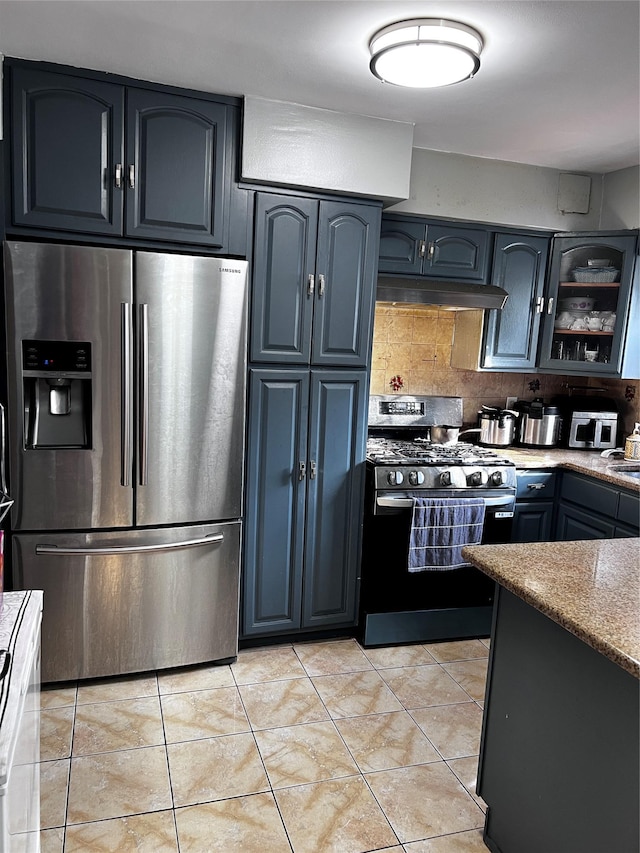 4153 Bruner Ave, Bronx, NY 10466 - kitchen with stainless steel appliances, backsplash, under cabinet range hood, glass insert cabinets, and blue cabinetry