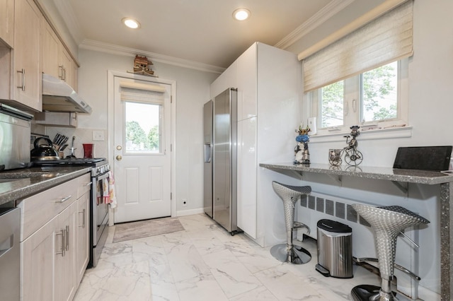 3300 Walters Ave, Wantagh, NY 11793 - kitchen with under cabinet range hood, appliances with stainless steel finishes, healthy amount of natural light, dark stone countertops, and recessed lighting