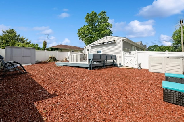 3300 Walters Ave, Wantagh, NY 11793 - fenced backyard featuring a deck, a gate, and a storage shed