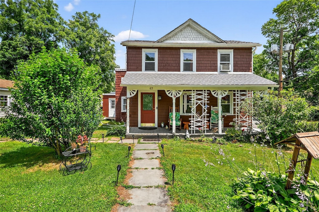 63 Orange St, Port Jervis, NY 12771 - view of front of house with a porch, a front yard, and a shingled roof