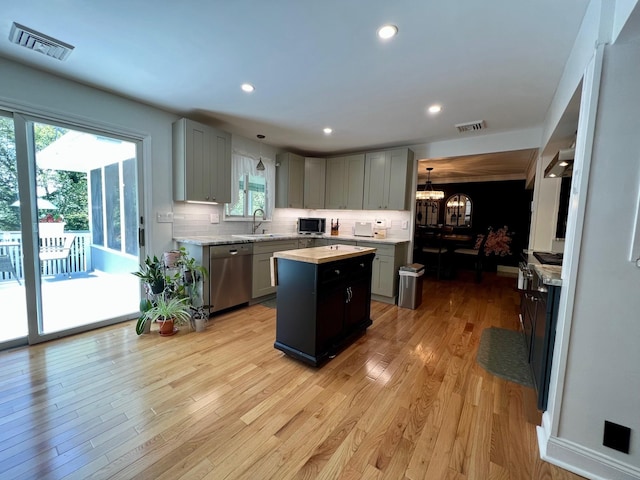 27 W Ave, Putnam Valley, NY 10579 - kitchen featuring stainless steel appliances, gray cabinets, a center island, light countertops, and a chandelier