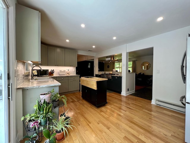 27 W Ave, Putnam Valley, NY 10579 - kitchen featuring light wood-style flooring, a center island, a baseboard heating unit, fridge, and gray cabinetry