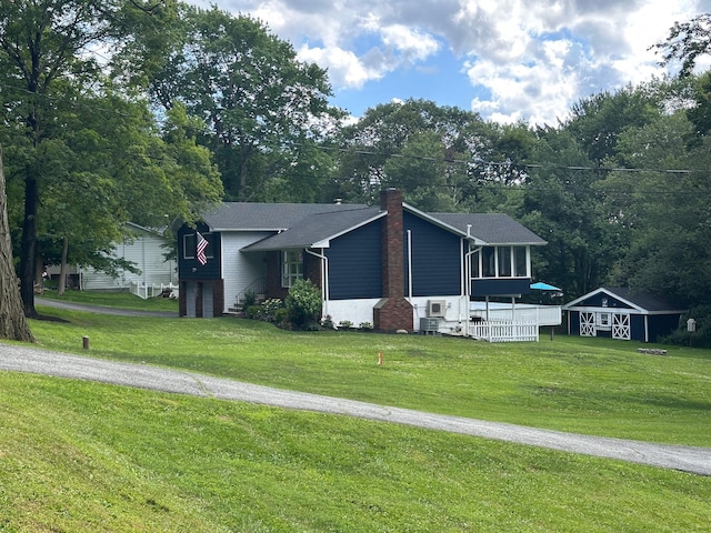 27 W Ave, Putnam Valley, NY 10579 - view of front of house with a front yard, a chimney, and driveway