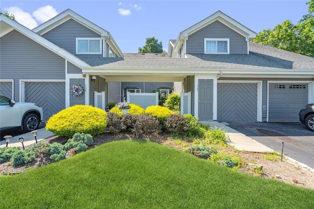 365 Seabreeze Ct, Moriches, NY 11955 - view of front of property featuring roof with shingles, a garage, a front yard, and driveway