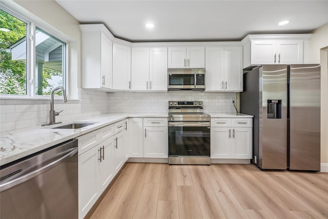 365 Seabreeze Ct, Moriches, NY 11955 - kitchen featuring stainless steel appliances, white cabinets, light wood-style flooring, light stone countertops, and recessed lighting