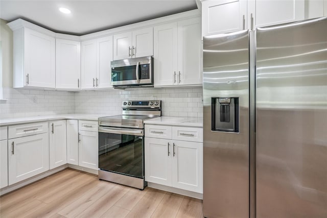 365 Seabreeze Ct, Moriches, NY 11955 - kitchen with stainless steel appliances, white cabinetry, light wood-style floors, backsplash, and recessed lighting