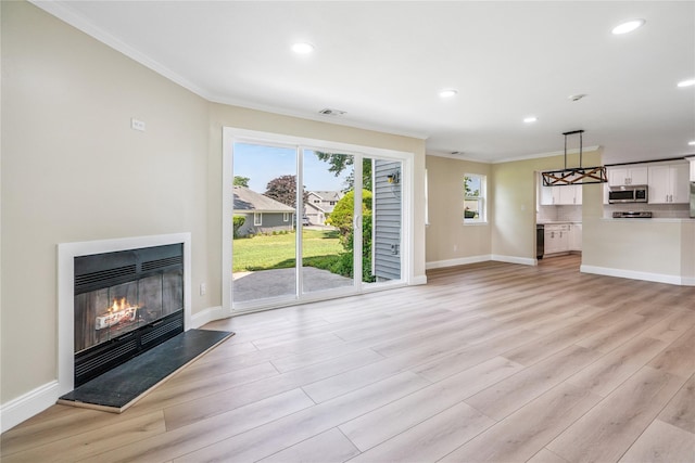 365 Seabreeze Ct, Moriches, NY 11955 - unfurnished living room featuring ornamental molding, a glass covered fireplace, light wood-type flooring, and recessed lighting