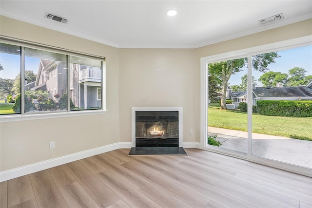 365 Seabreeze Ct, Moriches, NY 11955 - unfurnished living room featuring light wood-type flooring, a lit fireplace, crown molding, heating unit, and recessed lighting