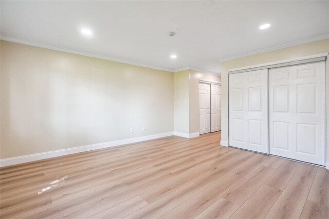 365 Seabreeze Ct, Moriches, NY 11955 - unfurnished bedroom featuring crown molding, light wood-style floors, recessed lighting, and two closets