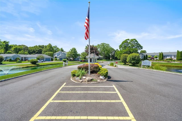 365 Seabreeze Ct, Moriches, NY 11955 - view of asphalt street featuring a water view, curbs, a residential view, and traffic signs