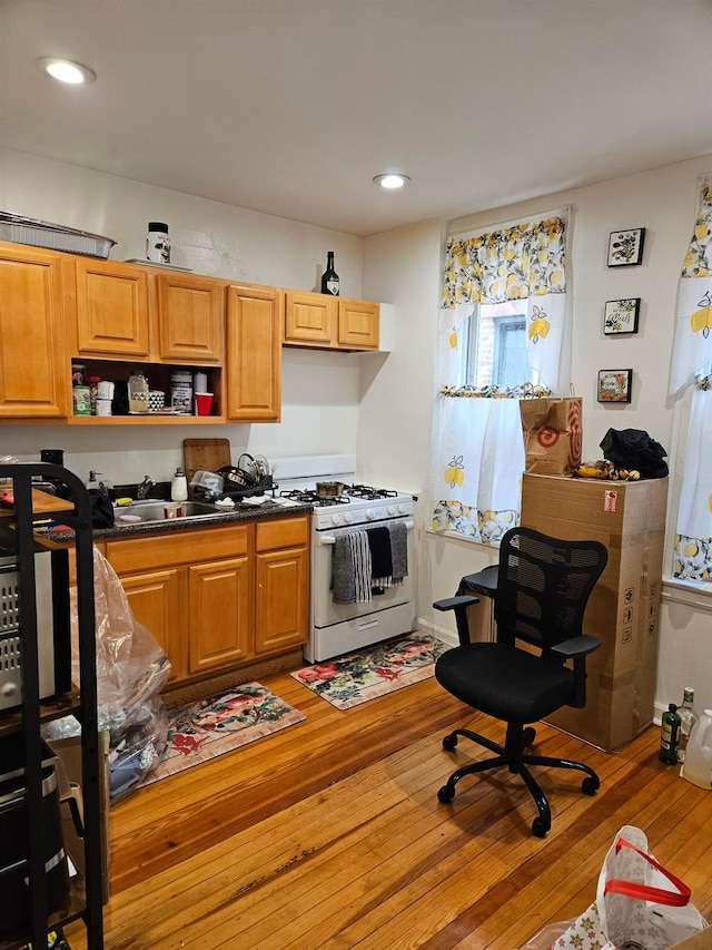 4439 Carpenter Ave, Bronx, NY 10470 - kitchen featuring white range with gas cooktop, light wood finished floors, dark countertops, open shelves, and recessed lighting